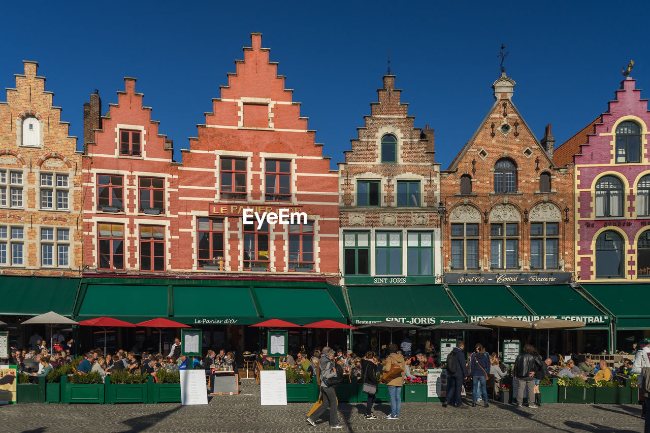 GROUP OF PEOPLE IN FRONT OF BUILDING