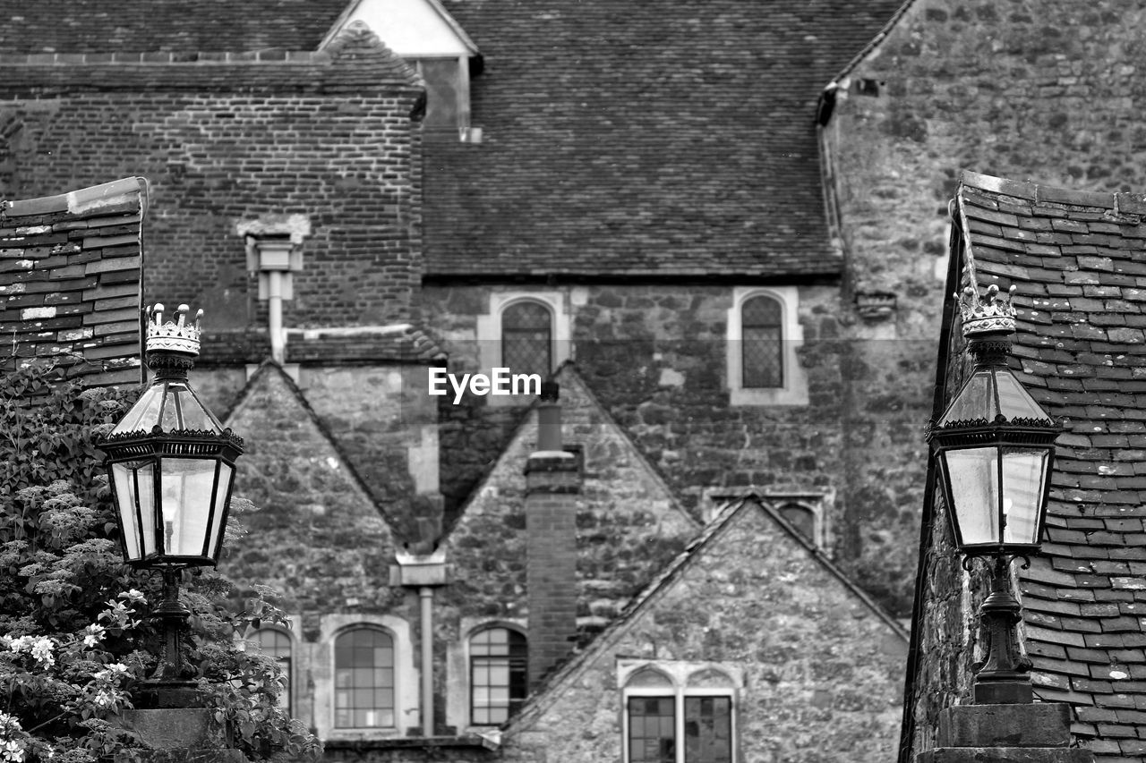 Low angle view of lantern against houses