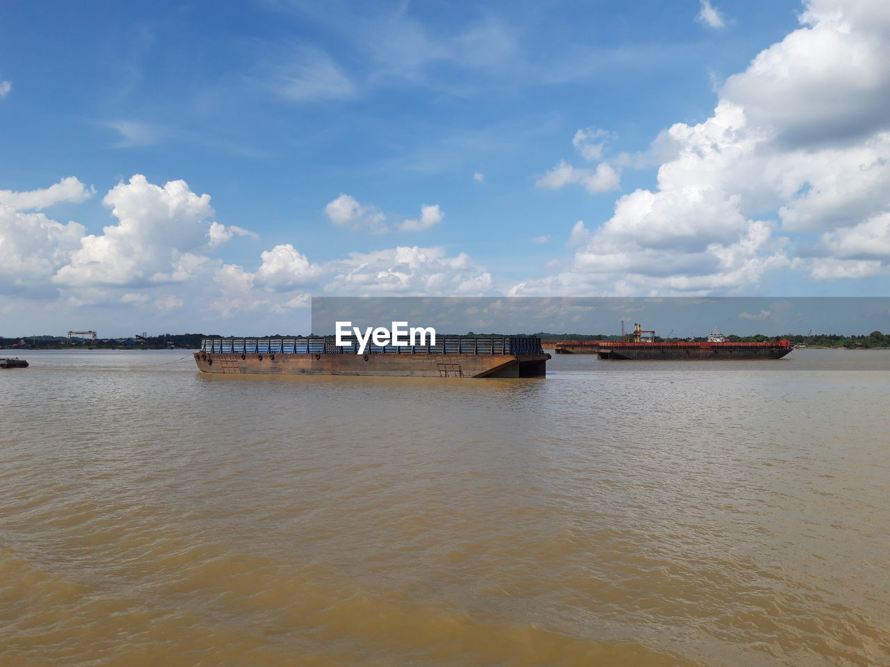 Barge traffic on the mahakam river, mahakam river, east kalimantan, indonesia