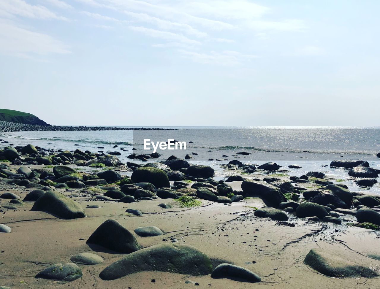 SURFACE LEVEL OF SEA SHORE AGAINST SKY