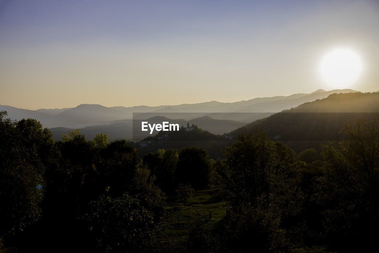 Scenic view of landscape against clear sky during sunset