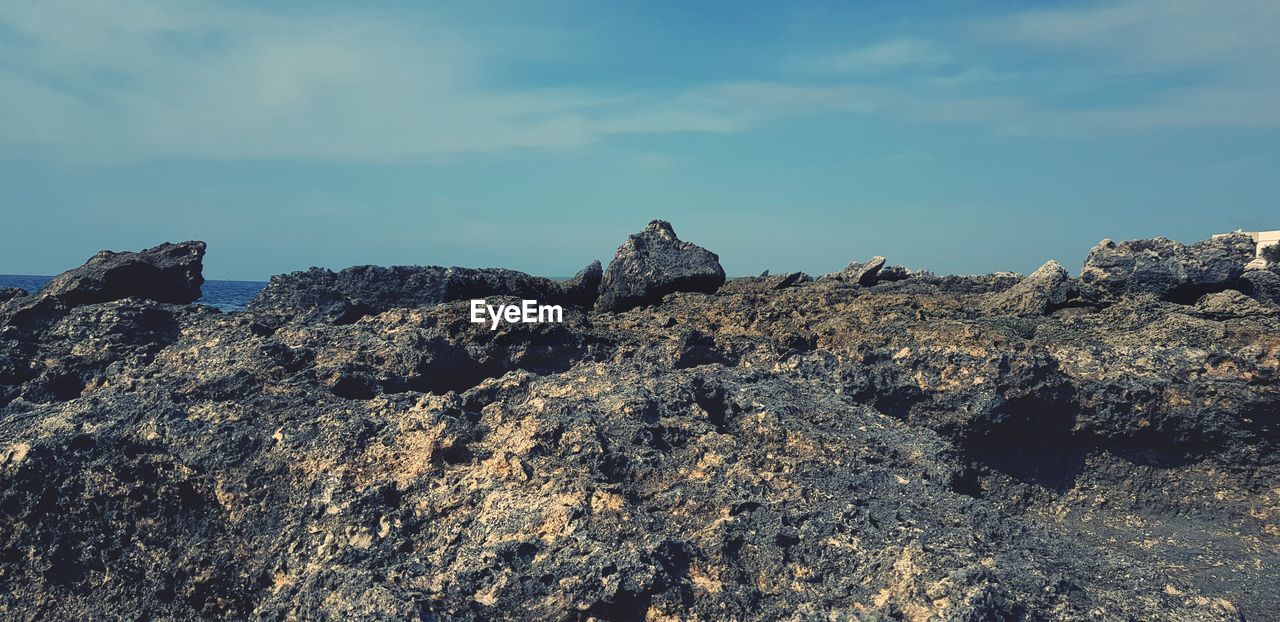 Low angle view of rock formations against sky