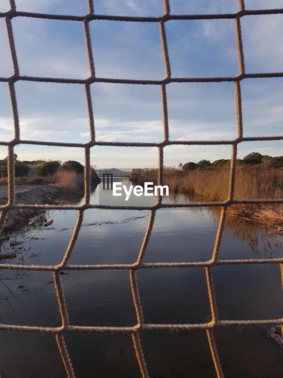 Scenic view of lake against sky seen through window