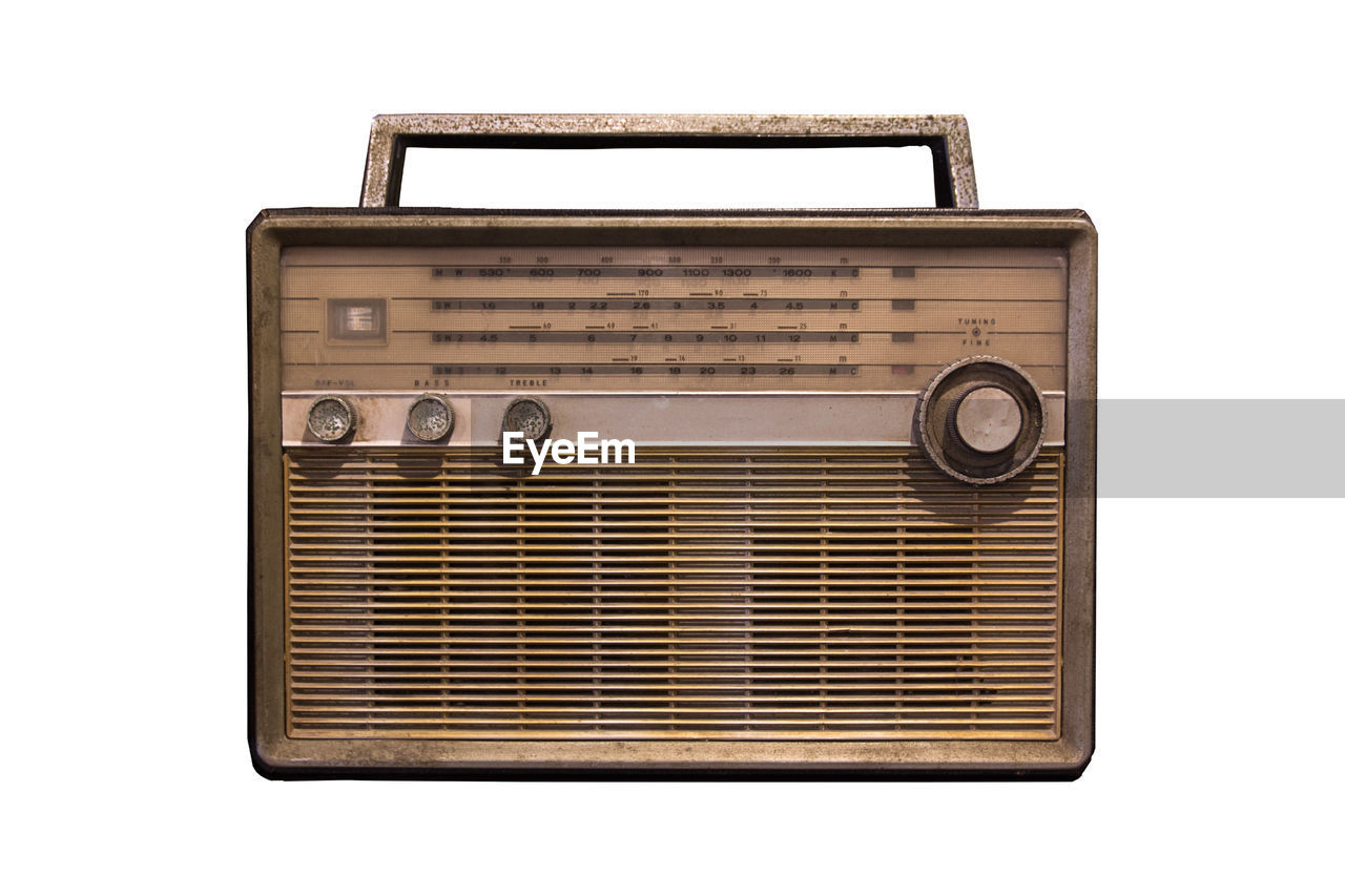 Close-up of old radio against white background