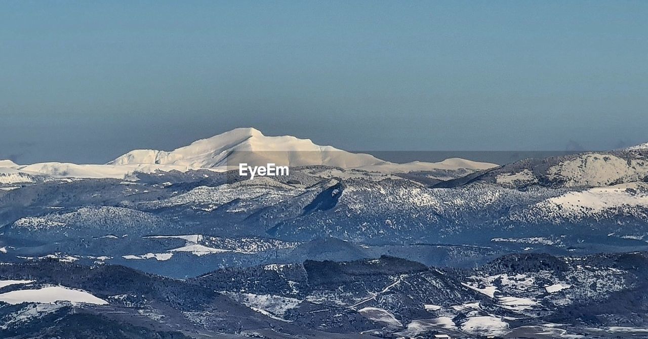 SNOW COVERED MOUNTAIN AGAINST SKY
