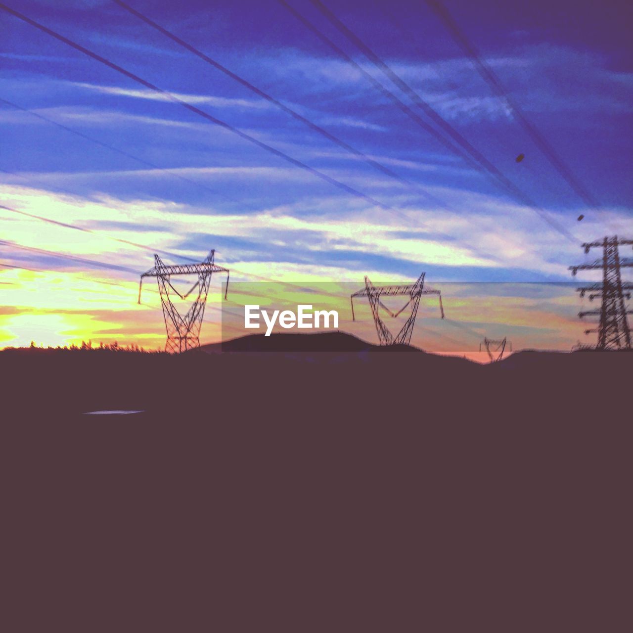 SILHOUETTE ELECTRICITY PYLON AGAINST SKY DURING SUNSET