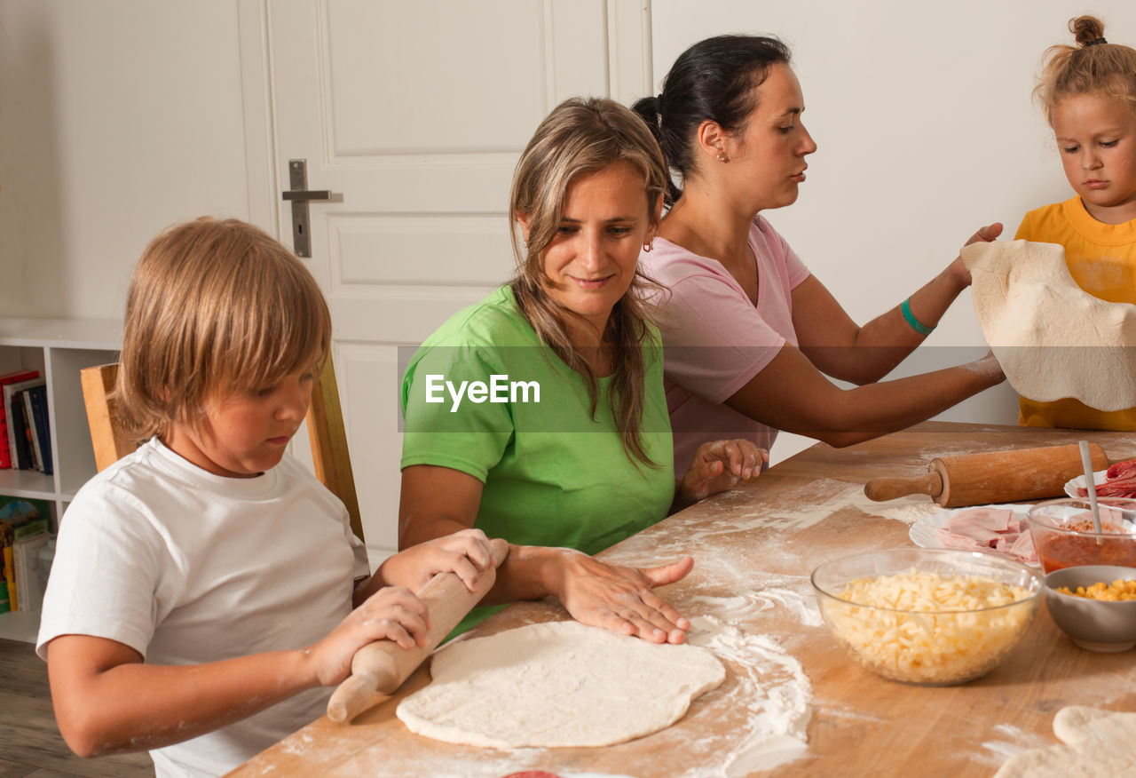 mother and daughter on table at home