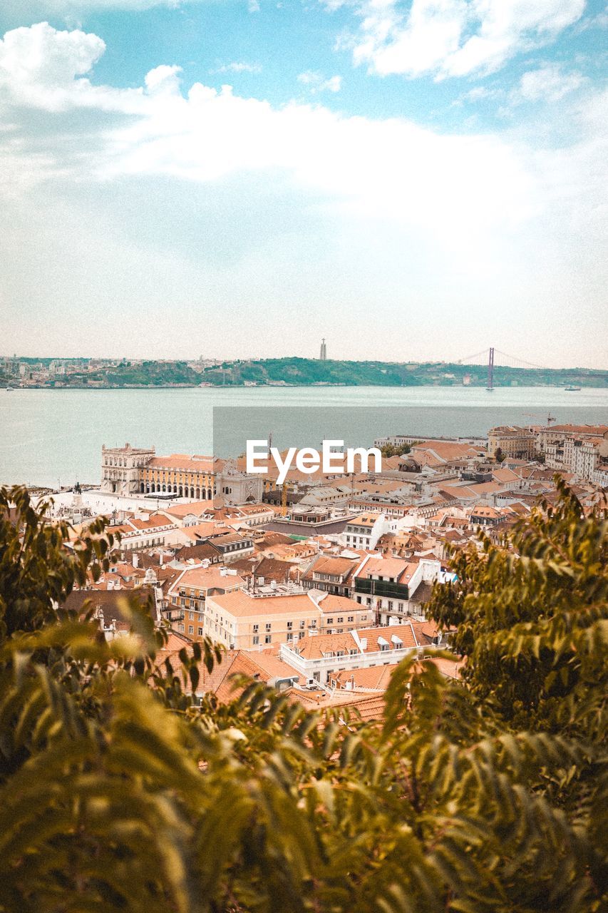 High angle view of sea and buildings against sky