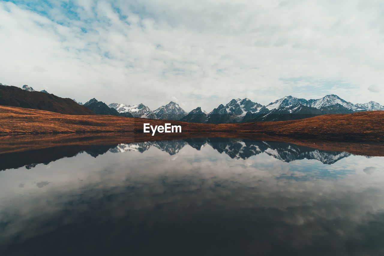 Reflection of mountains in lake against sky