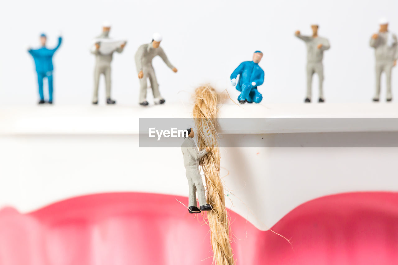 Close-up of dentures with figurines on white background