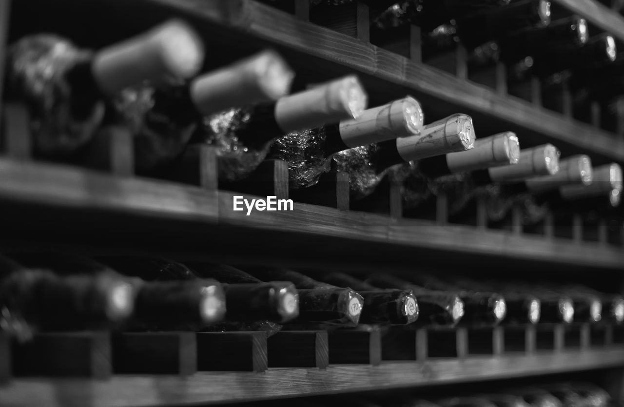Full frame shot of wine bottles in shelf