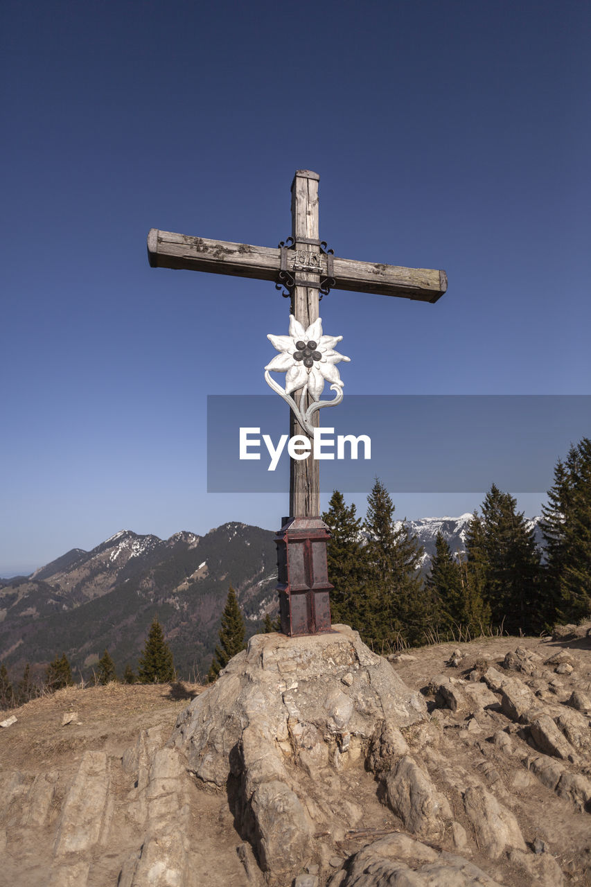 cross, religion, belief, spirituality, sky, catholicism, crucifix, nature, cross shape, landscape, symbol, no people, clear sky, blue, environment, place of worship, land, mountain, day, outdoors, scenics - nature, sunny, rural scene, architecture, travel destinations