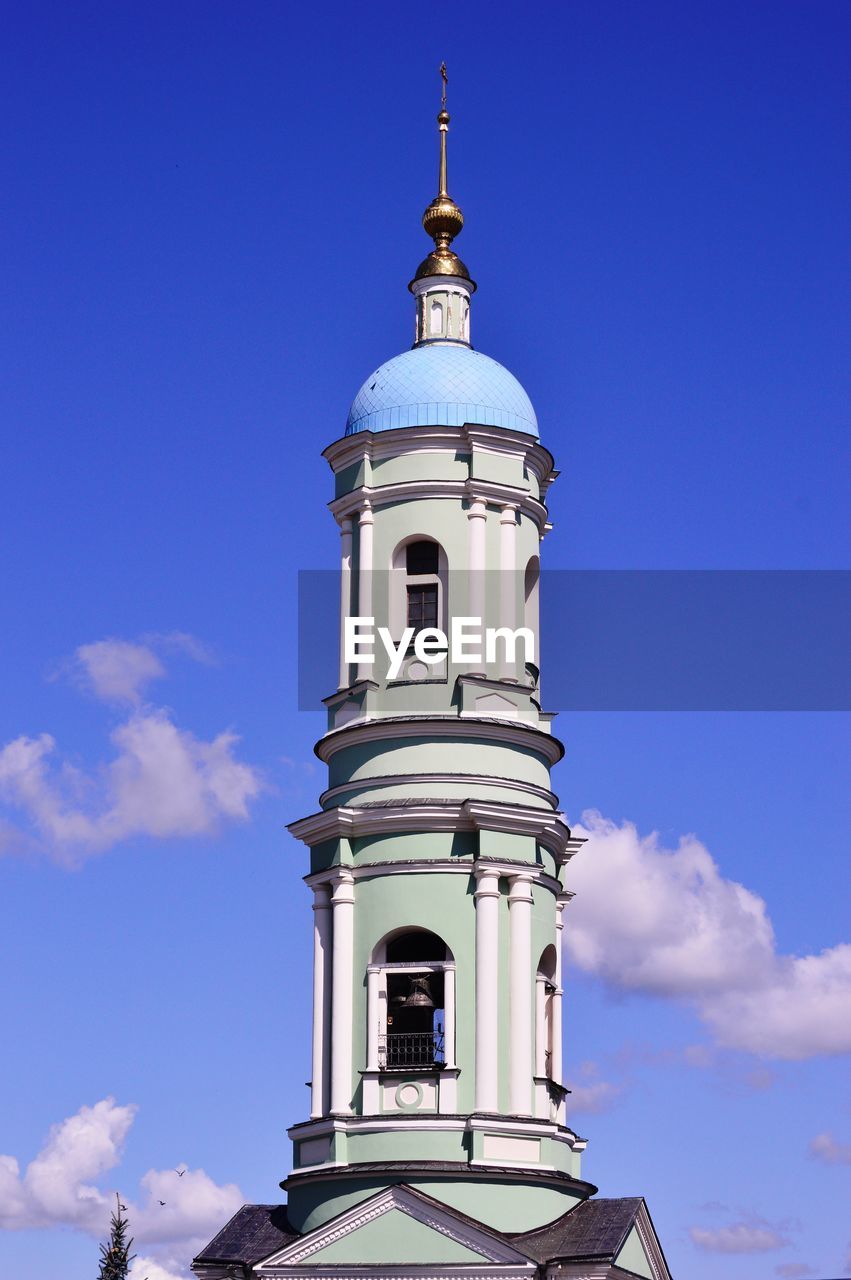 Low angle view of bell tower against blue sky