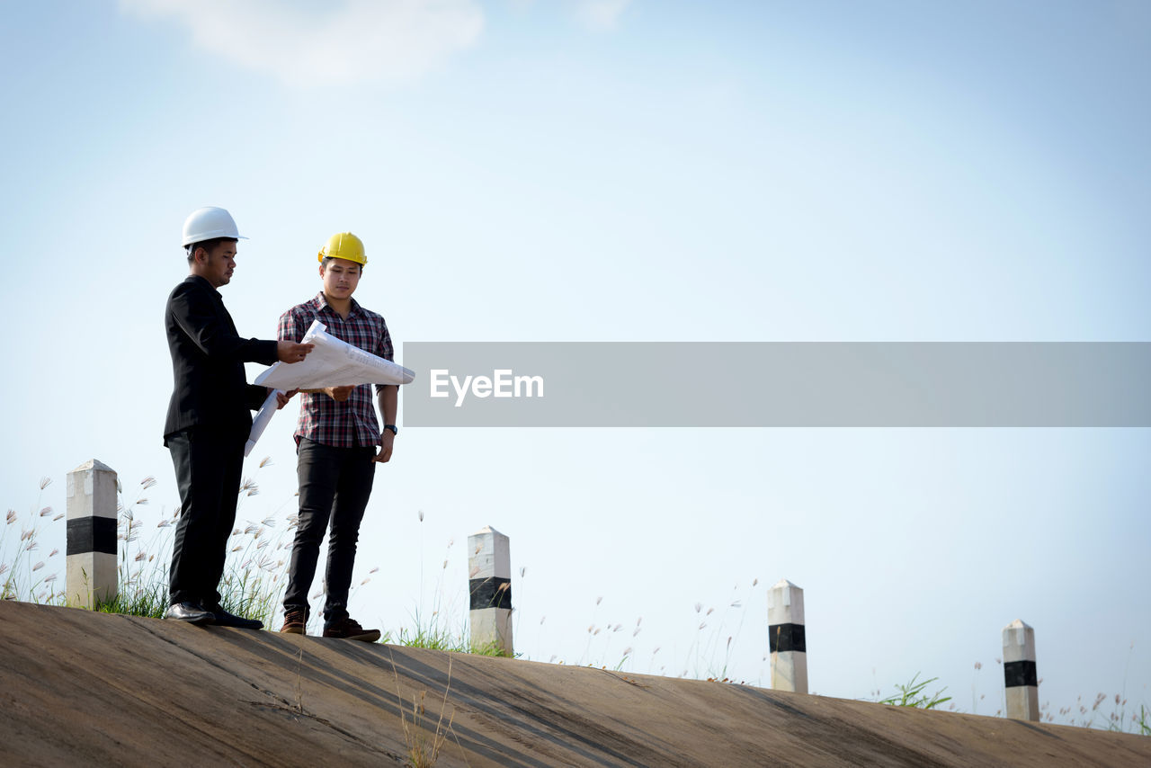 MAN WORKING WITH ARMS RAISED