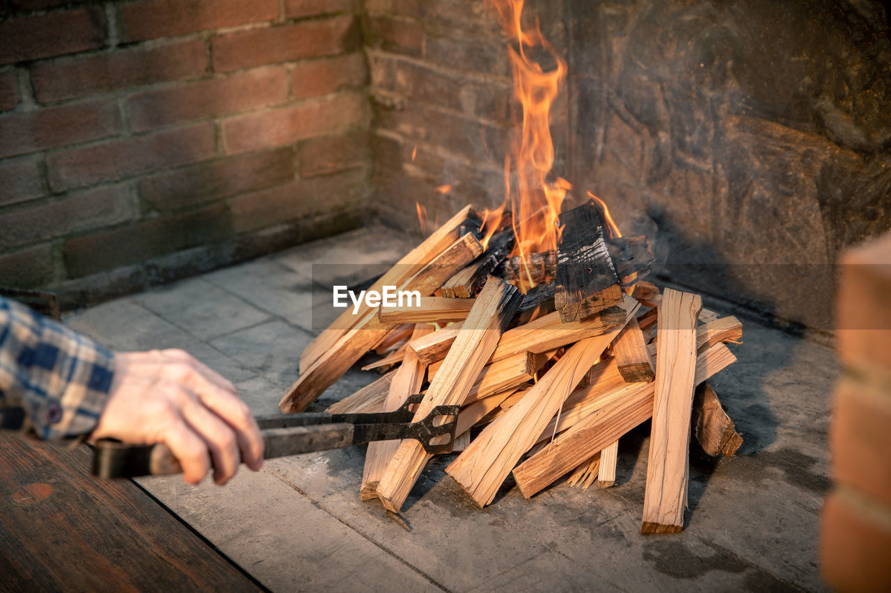 Closeup of pyre of burning wood with flames. production of charcoal for grilling meat wood logs burn