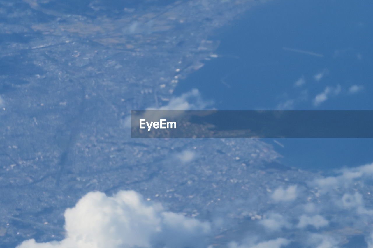 AERIAL VIEW OF SNOWCAPPED MOUNTAINS AGAINST SKY