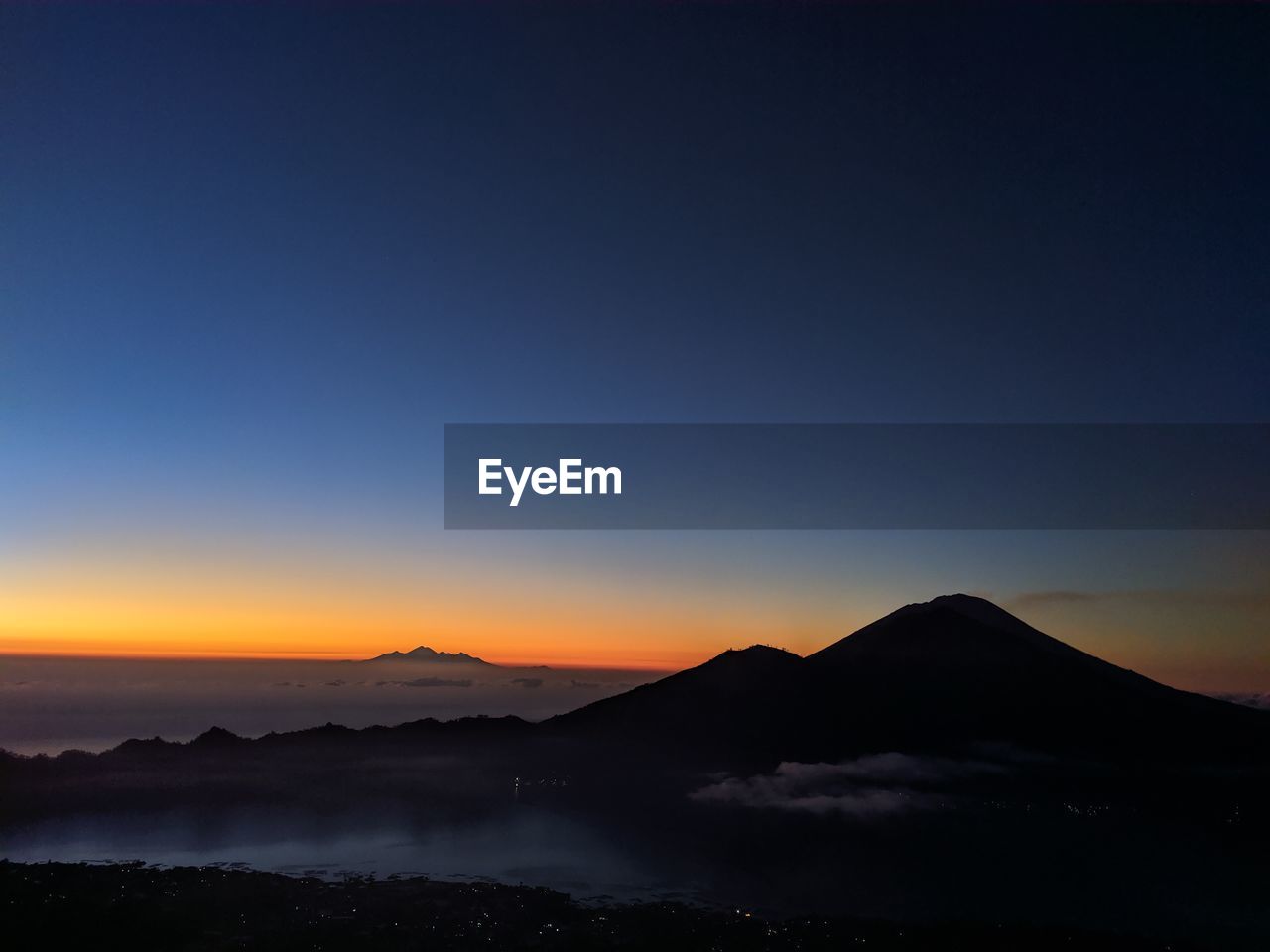 Scenic view of silhouette mountains against sky at sunset