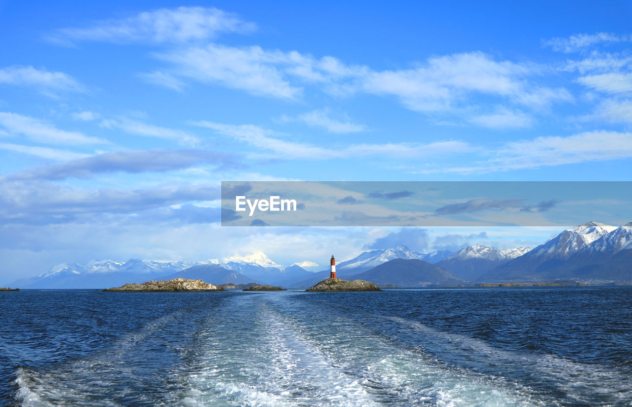 MAN ON SHORE AGAINST SKY