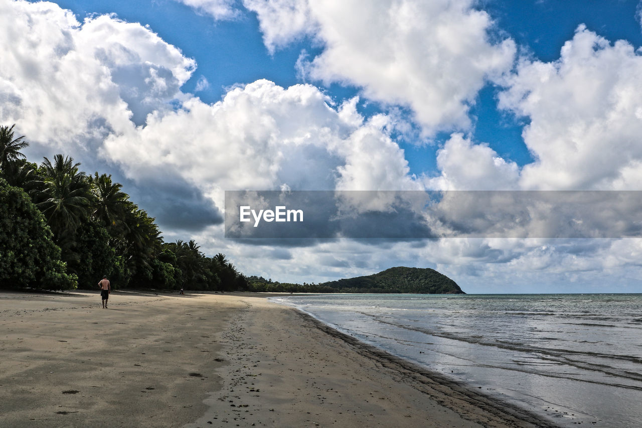 Man on beach against sky