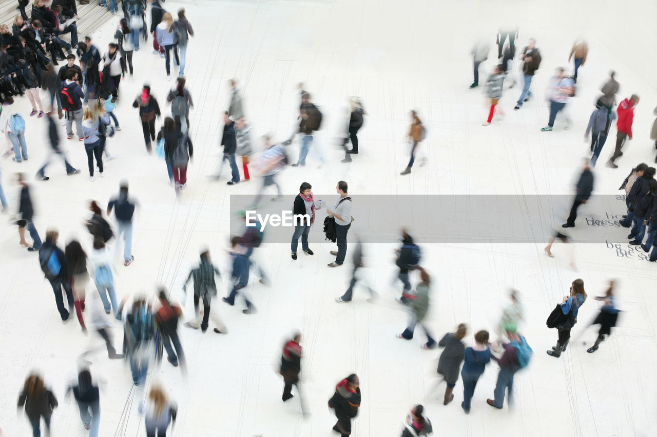 GROUP OF PEOPLE WALKING IN CITY