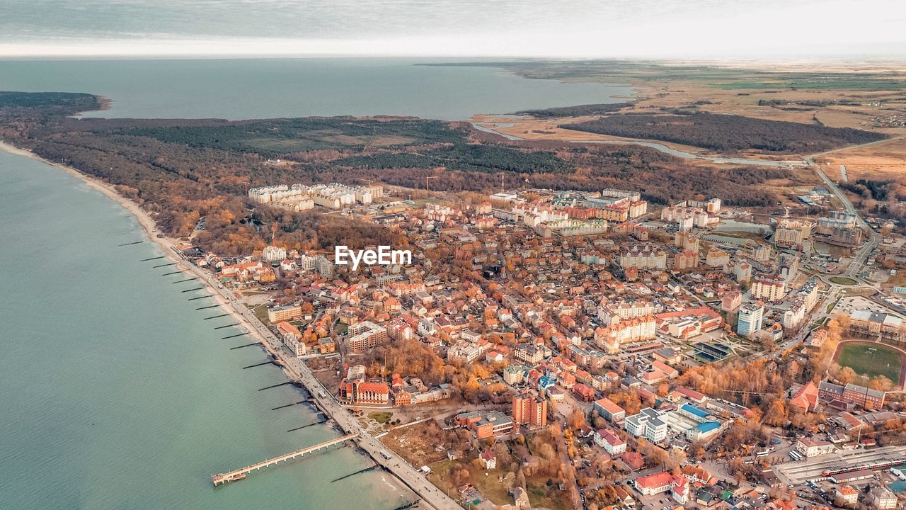 High angle view of sea and buildings against sky