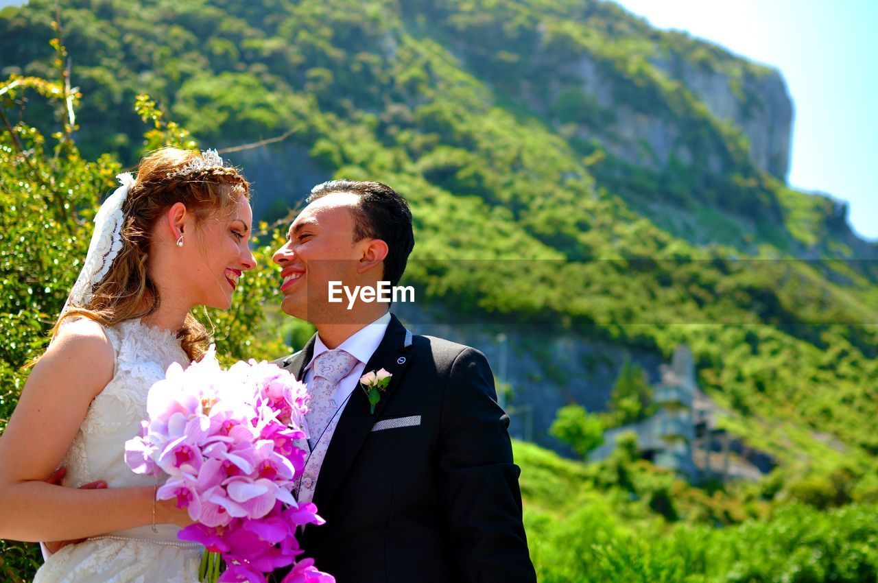 Side view of bride with bouquet