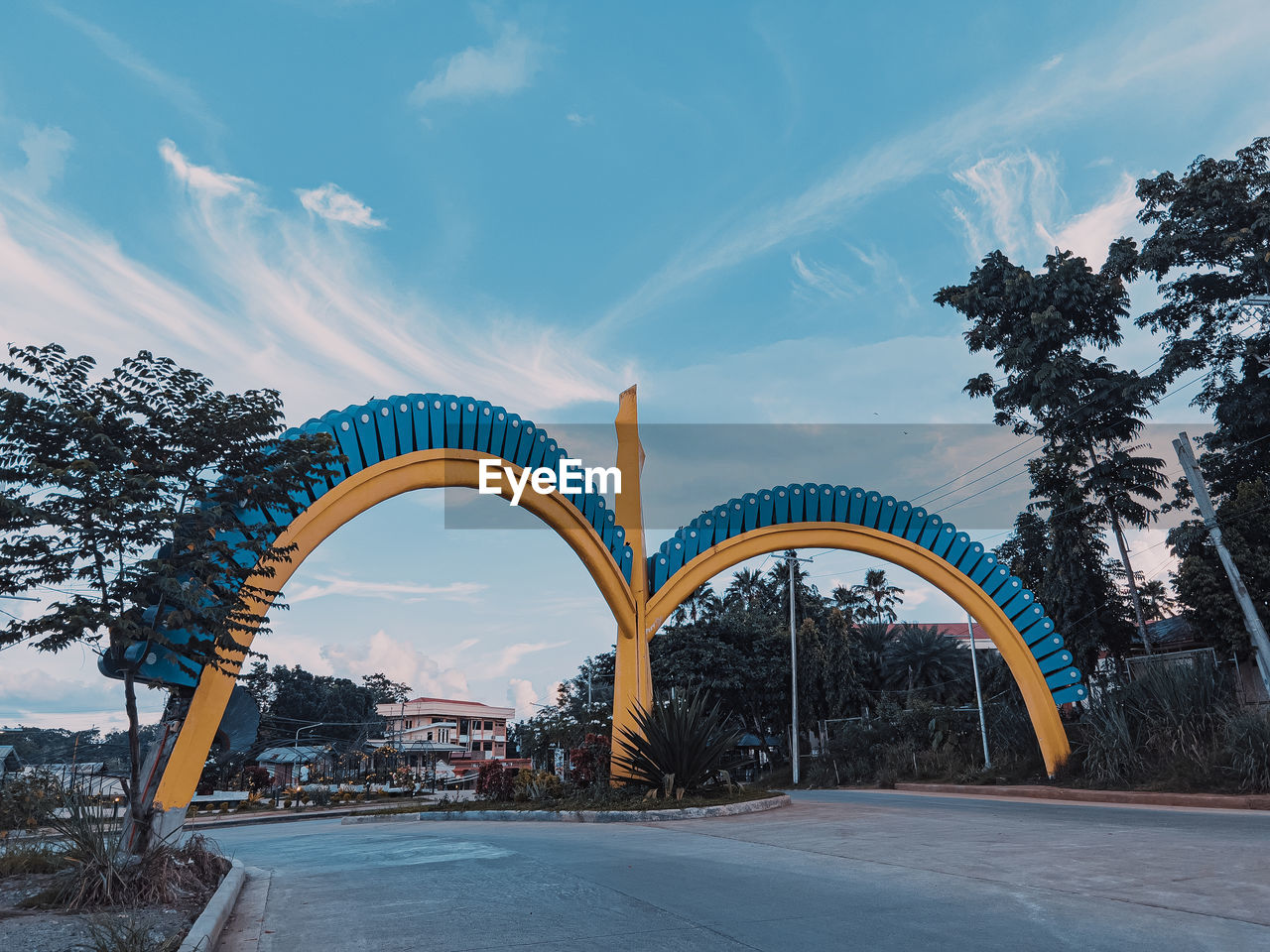 architecture, arch, landmark, sky, built structure, nature, city, tree, cloud, travel destinations, transportation, bridge, no people, blue, plant, outdoors, travel, road, snow, arts culture and entertainment, winter, water, building exterior, park