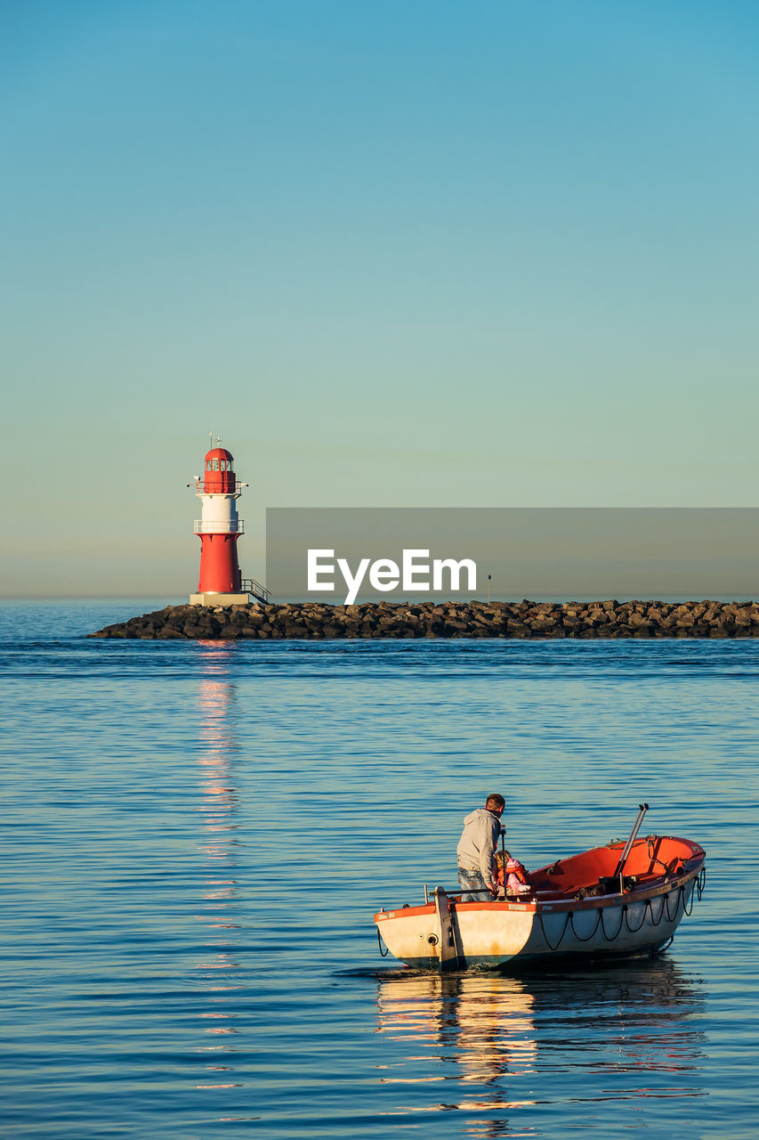 BOAT ON SEA AGAINST CLEAR SKY