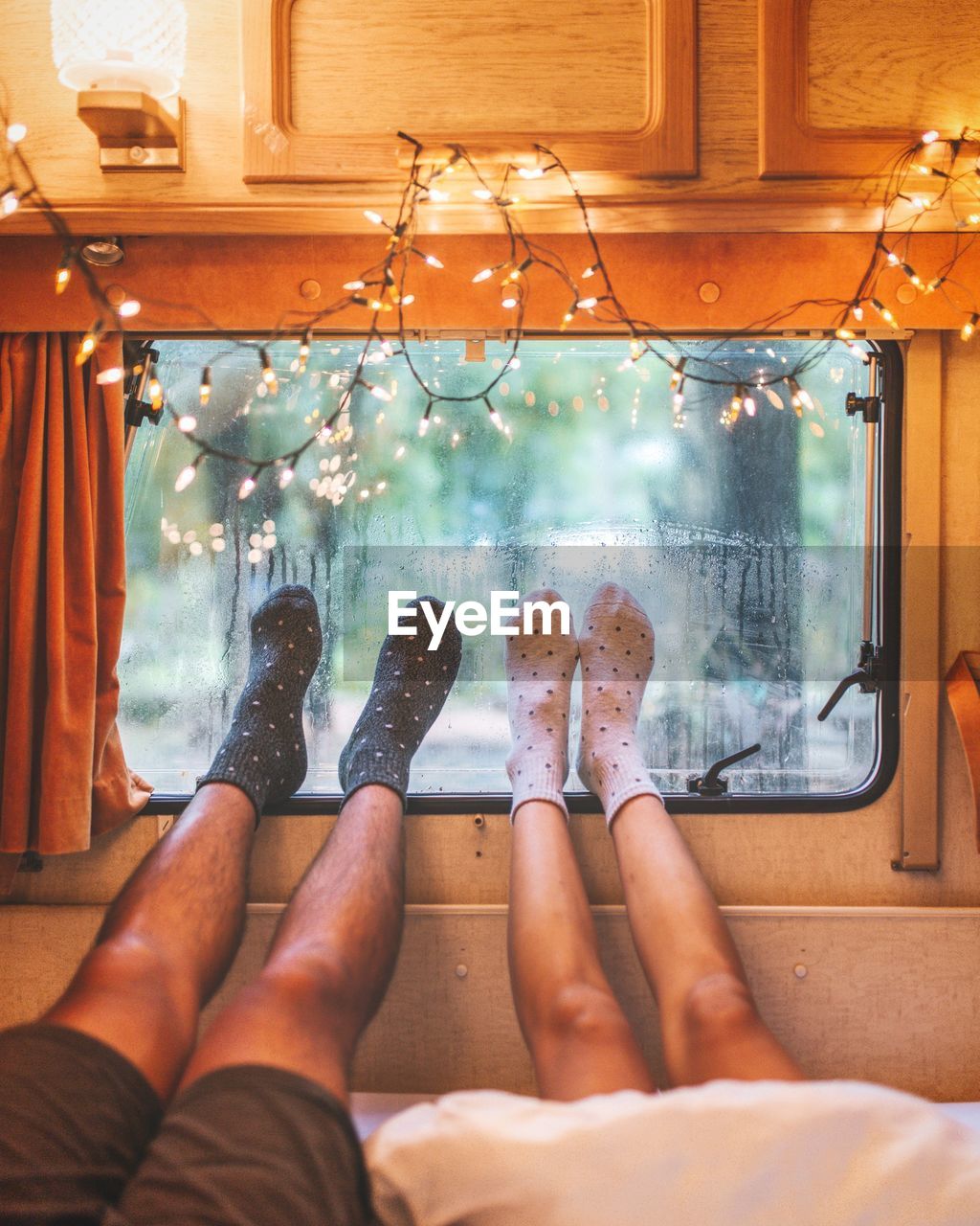 Low section of couple relaxing in motor home