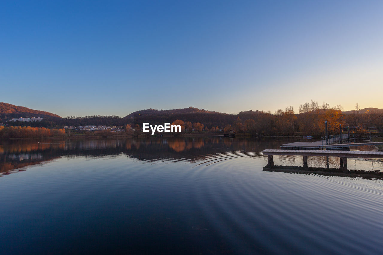 Hills reflected on a lake during an autumn sunset