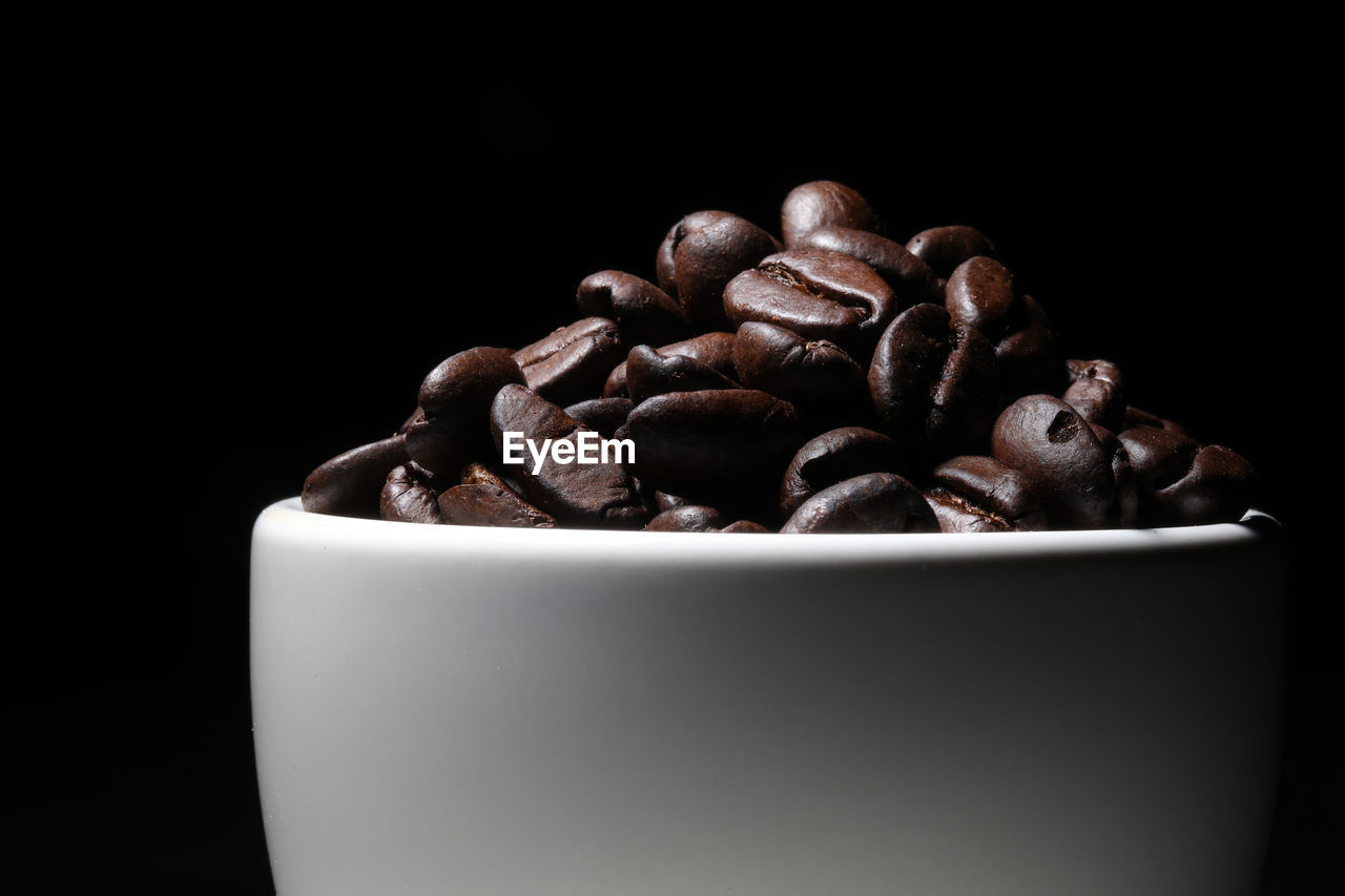 Close-up of coffee beans against black background