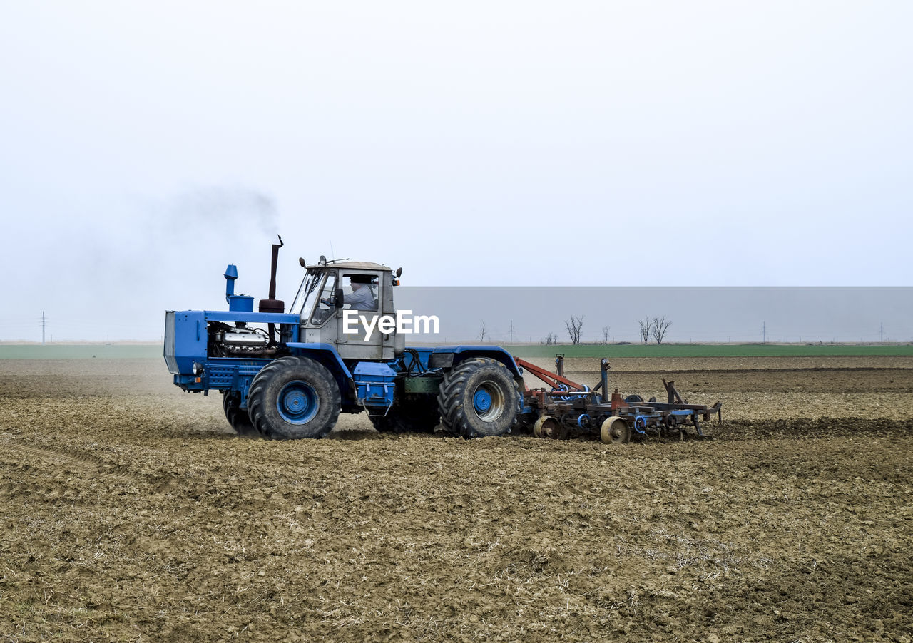 TRACTOR ON AGRICULTURAL FIELD