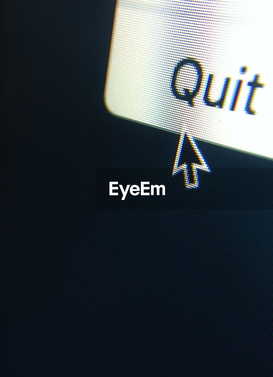 Close-up of quit text and cursor on device screen