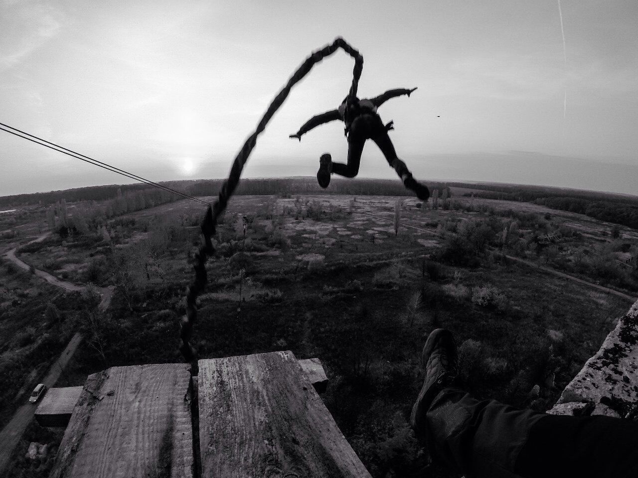 Rear view of person bumping jumping over landscape