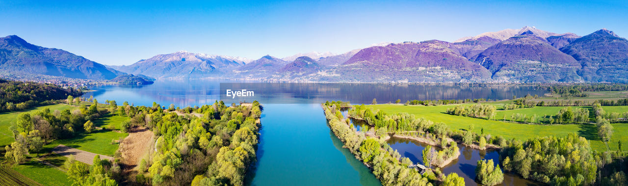 PANORAMIC SHOT OF LAKE AGAINST CLEAR BLUE SKY