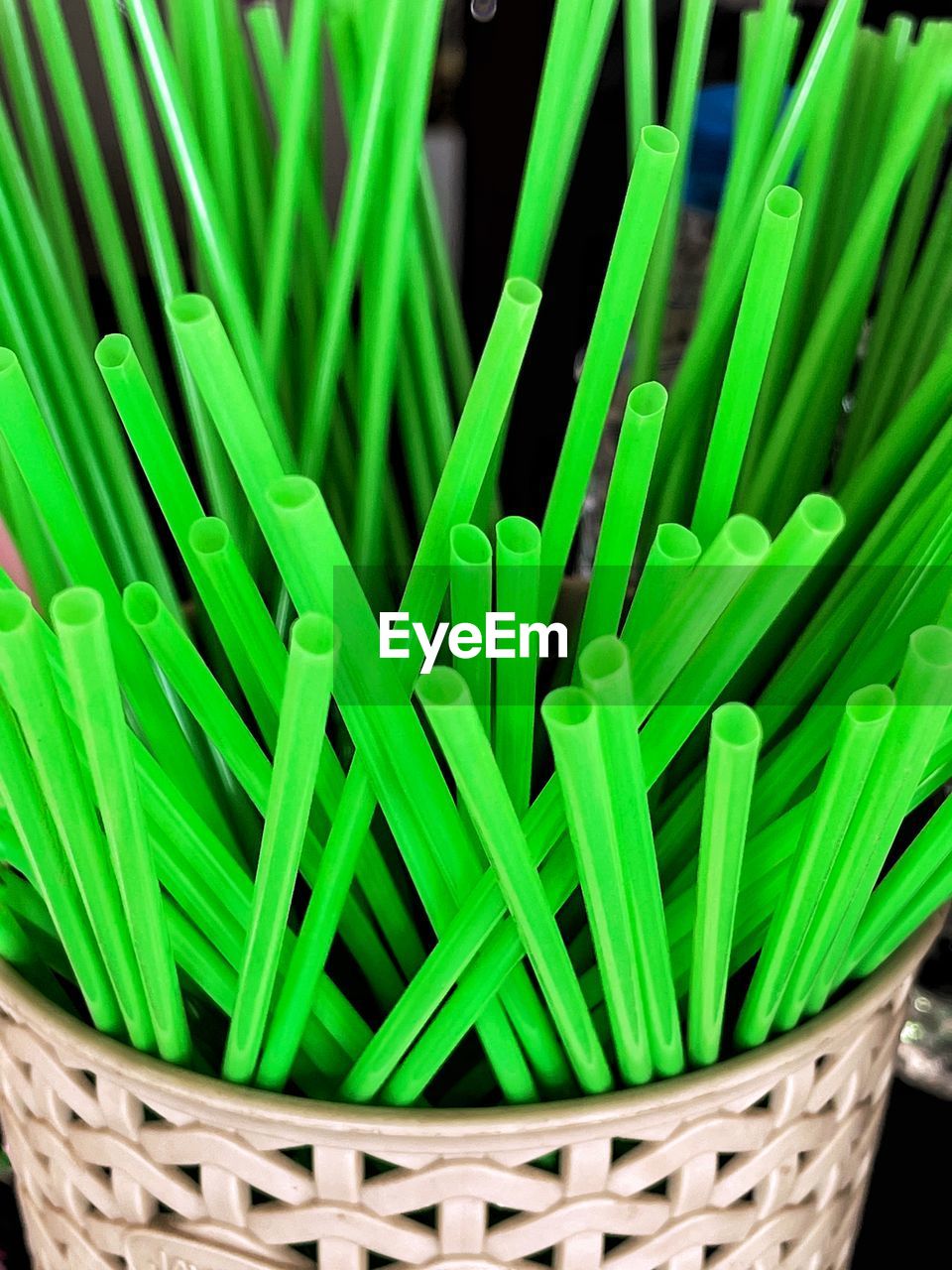 High angle view of plastic straws in basket