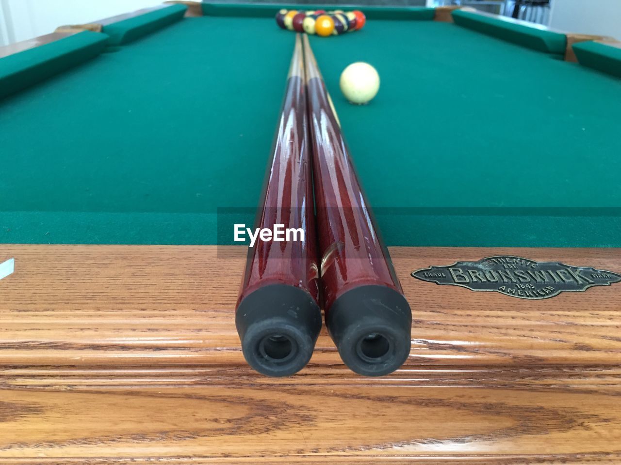 Close-up of cue with balls on pool table