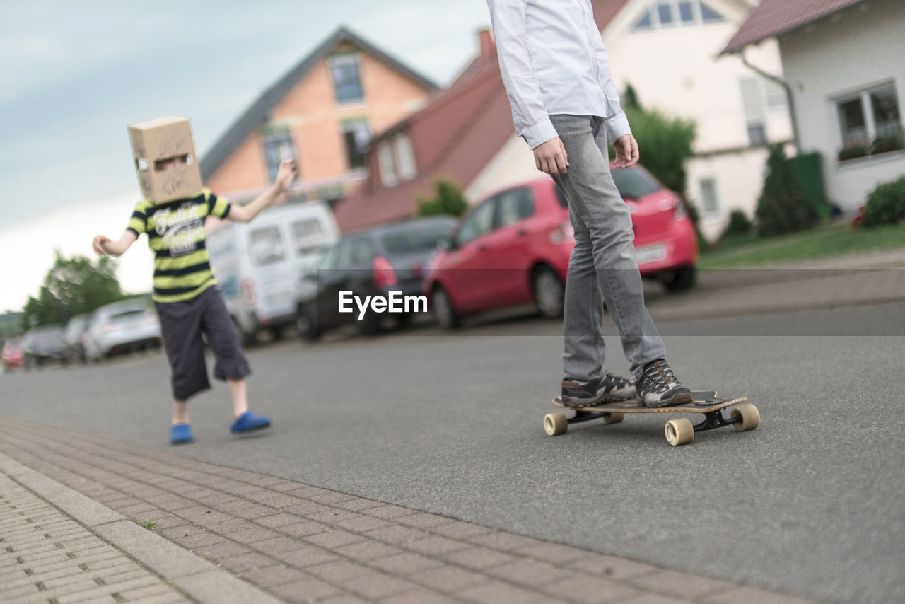 Low section of boy skateboarding