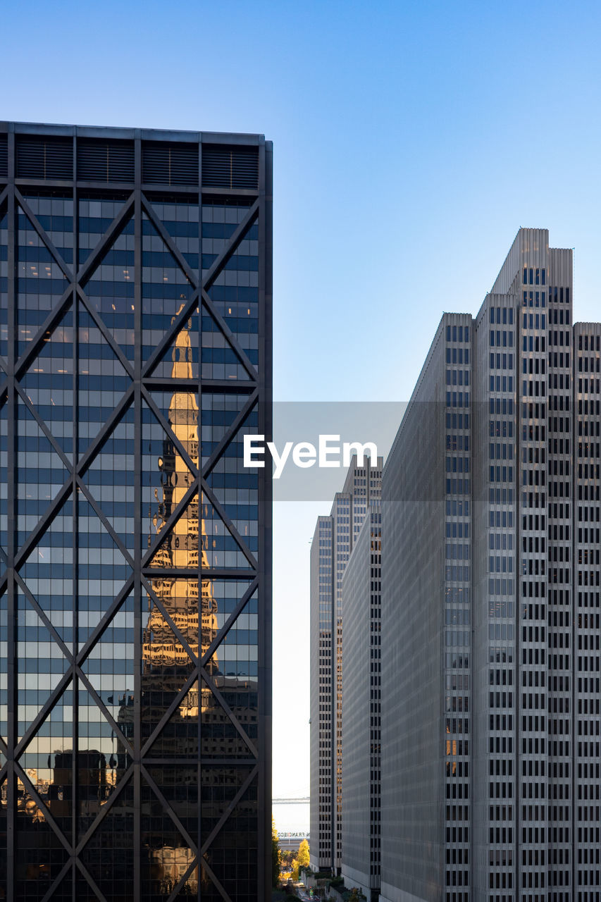 Low angle view of skyscrapers with reflection