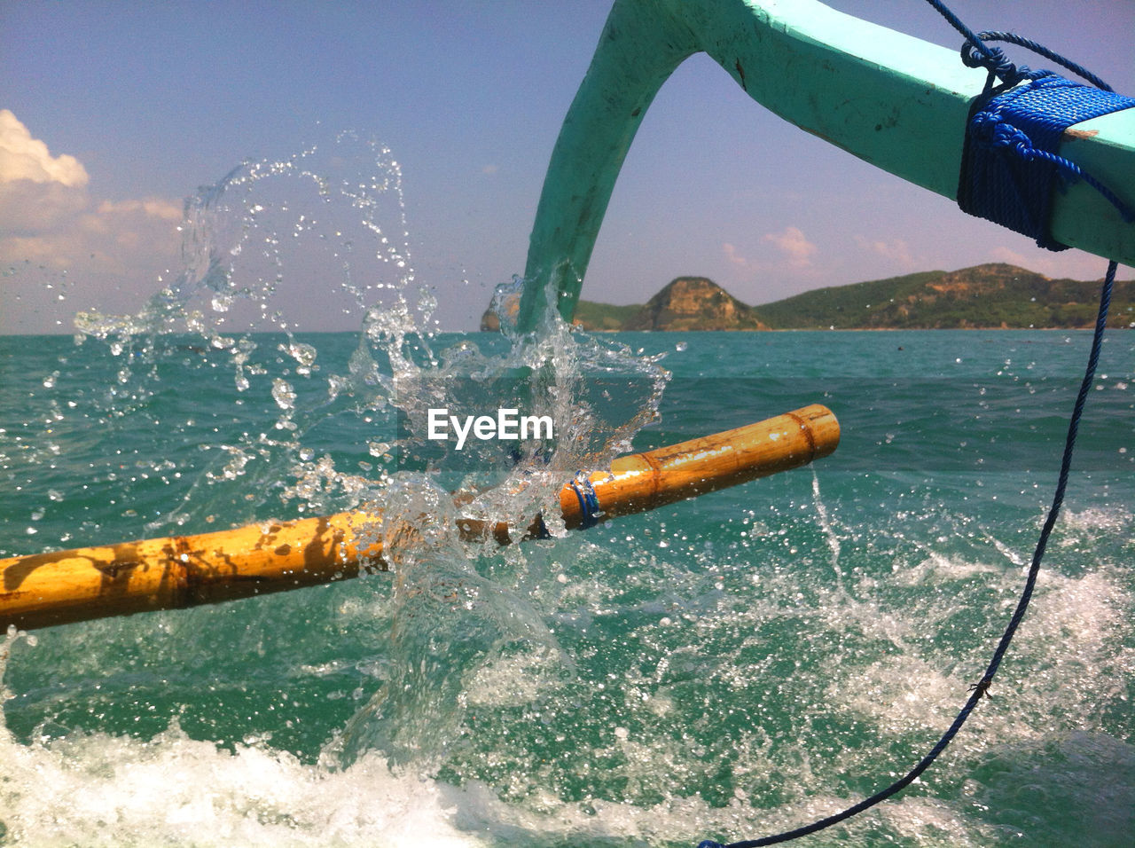 Cropped image of outrigger boat sailing in sea