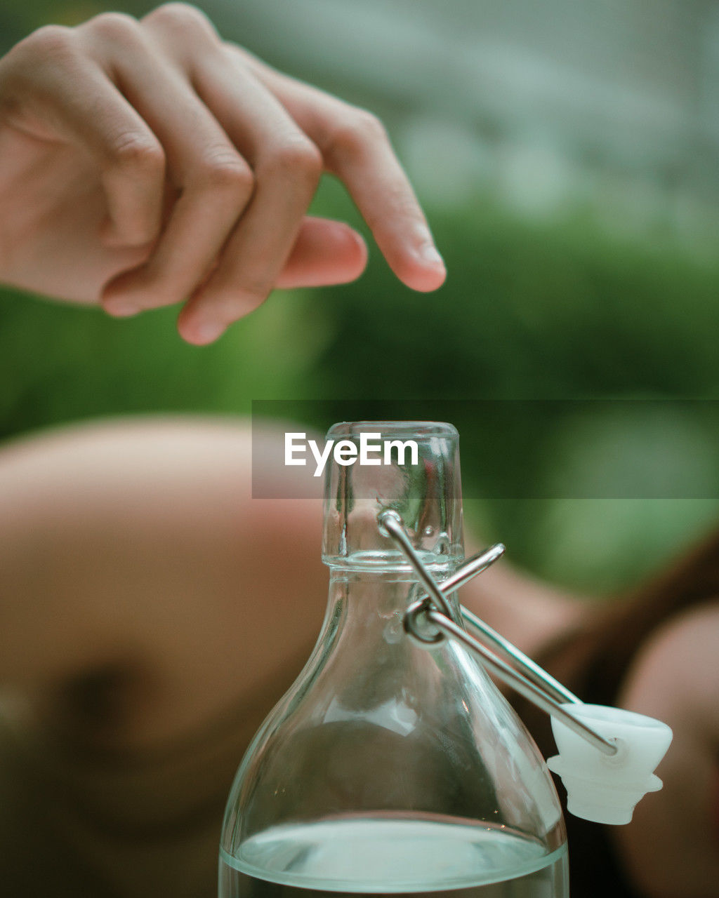 hand, green, close-up, bottle, one person, glass, holding, food and drink, container, drink, focus on foreground, refreshment, adult, alcohol, nature, women, drinking glass, outdoors, pouring, jar, water, food, day