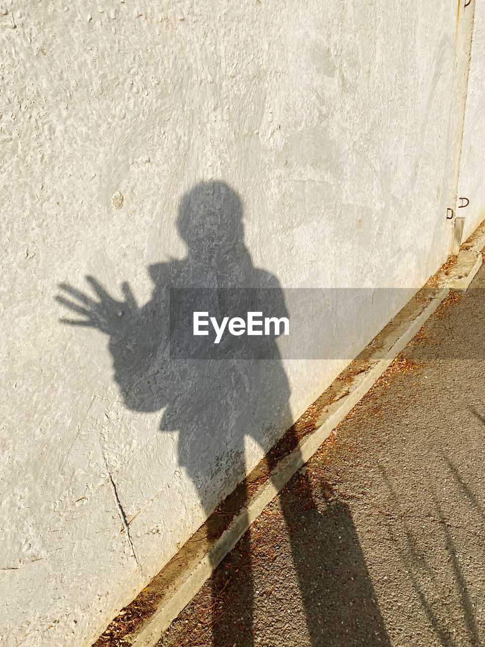 HIGH ANGLE VIEW OF SHADOW ON STREET