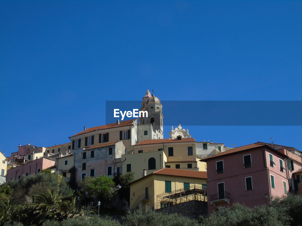 Low angle view of buildings against clear blue sky