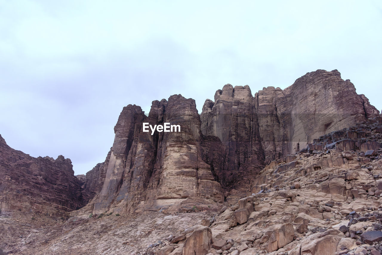 rock, rock formation, sky, scenics - nature, landscape, environment, nature, beauty in nature, travel destinations, land, mountain, cloud, non-urban scene, travel, no people, geology, terrain, desert, outdoors, tranquility, cliff, extreme terrain, wadi, eroded, wilderness, tranquil scene, day, mountain range, physical geography, tourism, valley, plateau, climate, formation, arid climate, remote, outdoor pursuit, plant