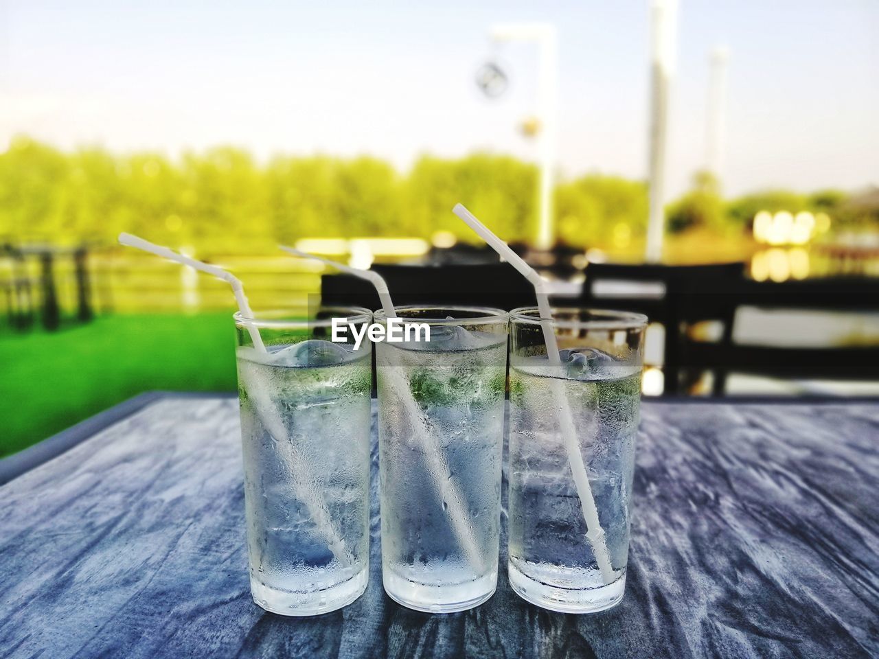 CLOSE-UP OF DRINKING GLASS ON TABLE