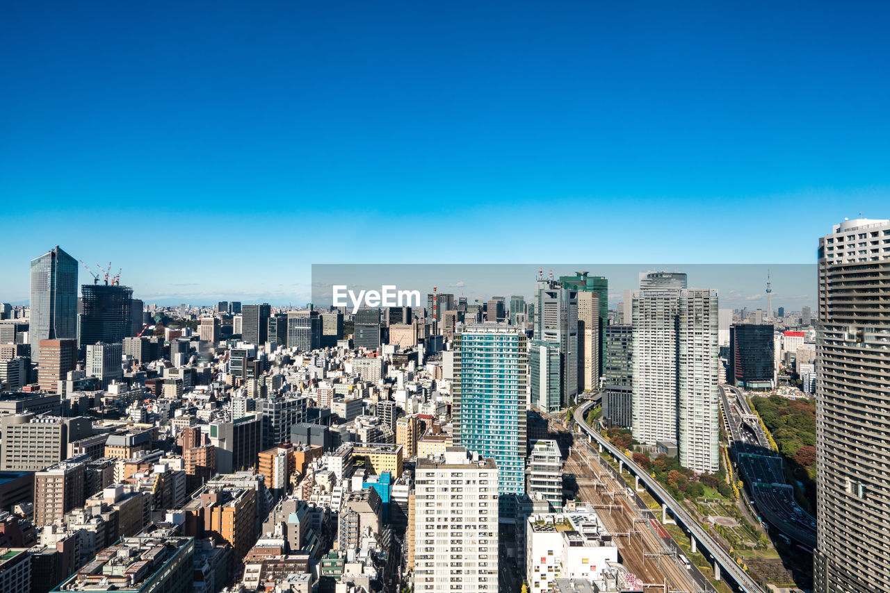 Aerial view of modern buildings against clear blue sky