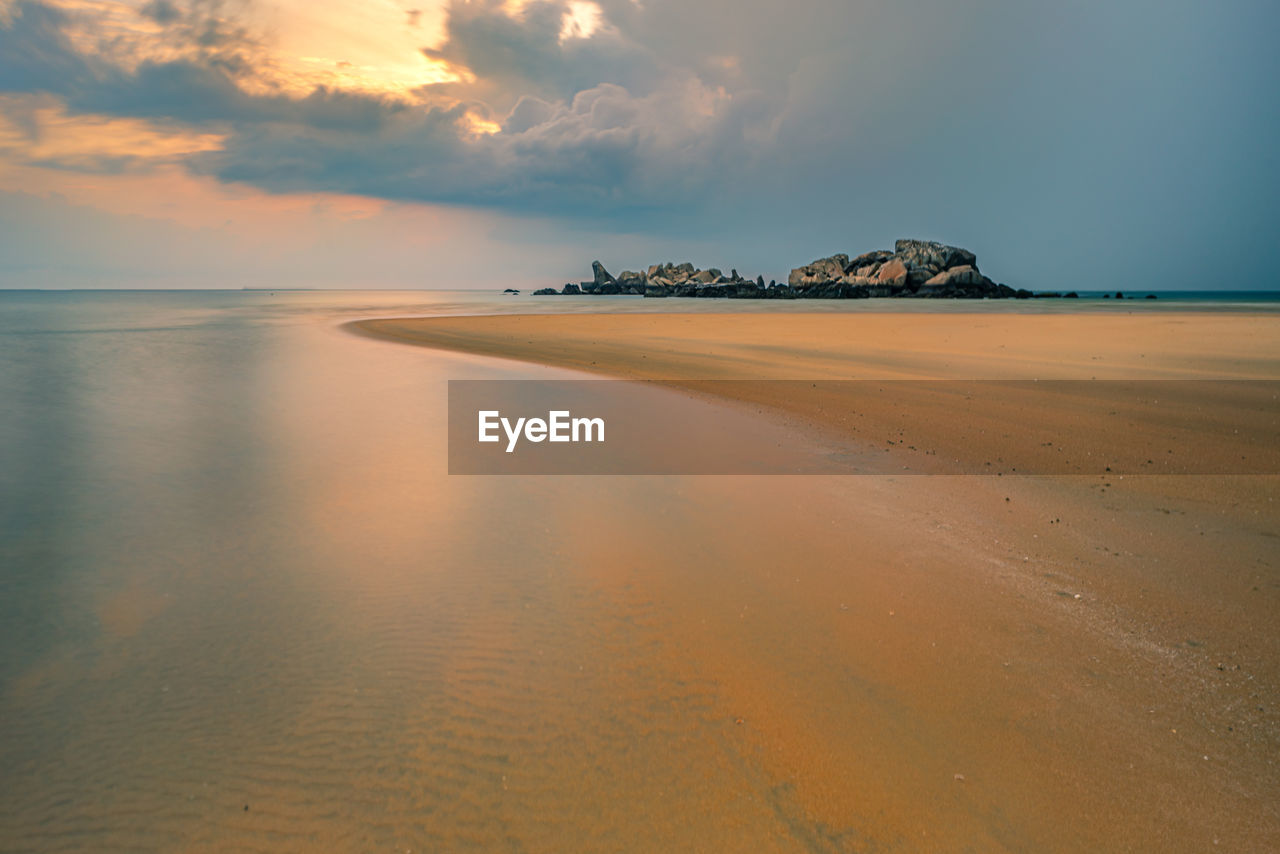 Scenic view of beach against sky during sunset