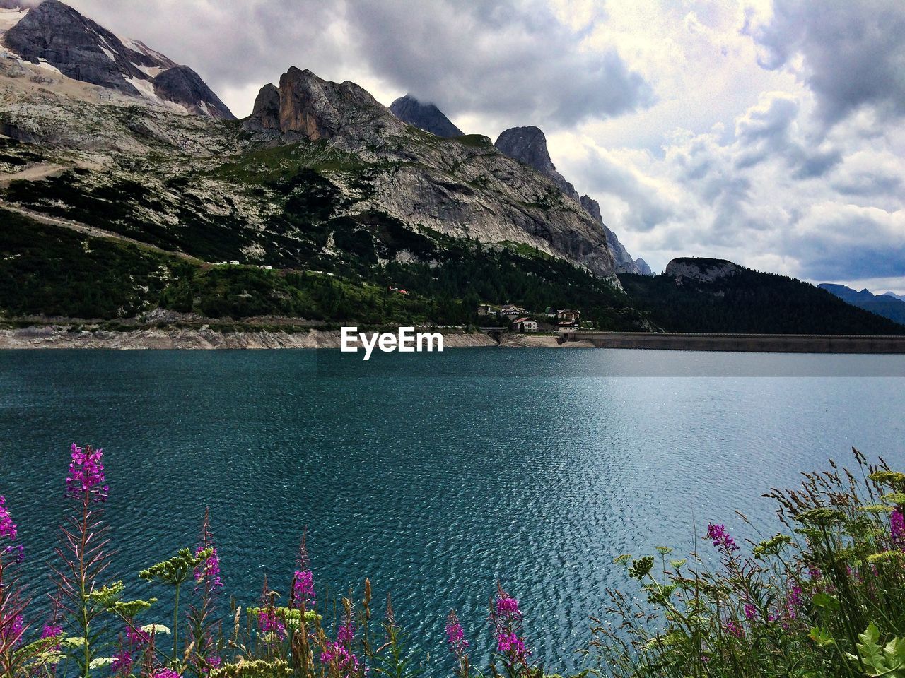 Scenic view of sea and mountains against sky