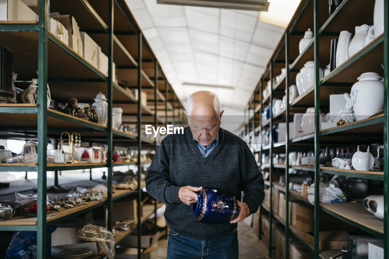 Elderly man reviewing the ceramic piece