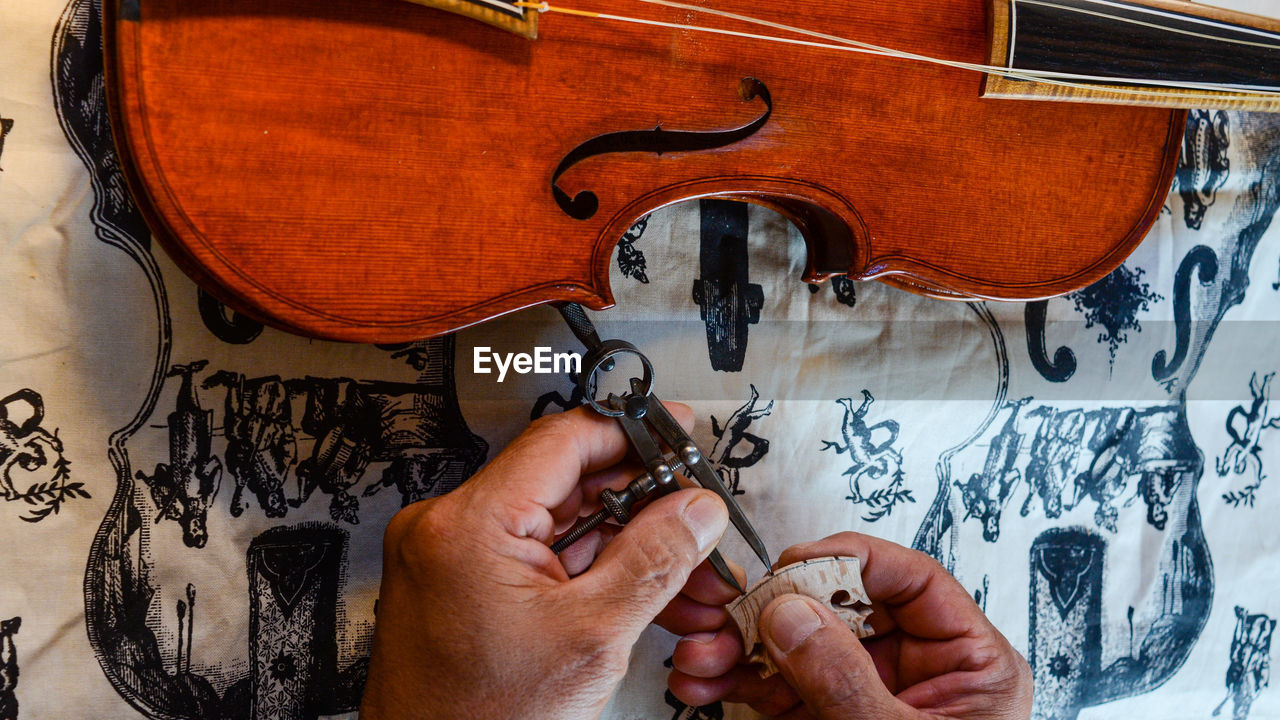 Violin violin maker luthier changing bridge of a handmade baroque viol